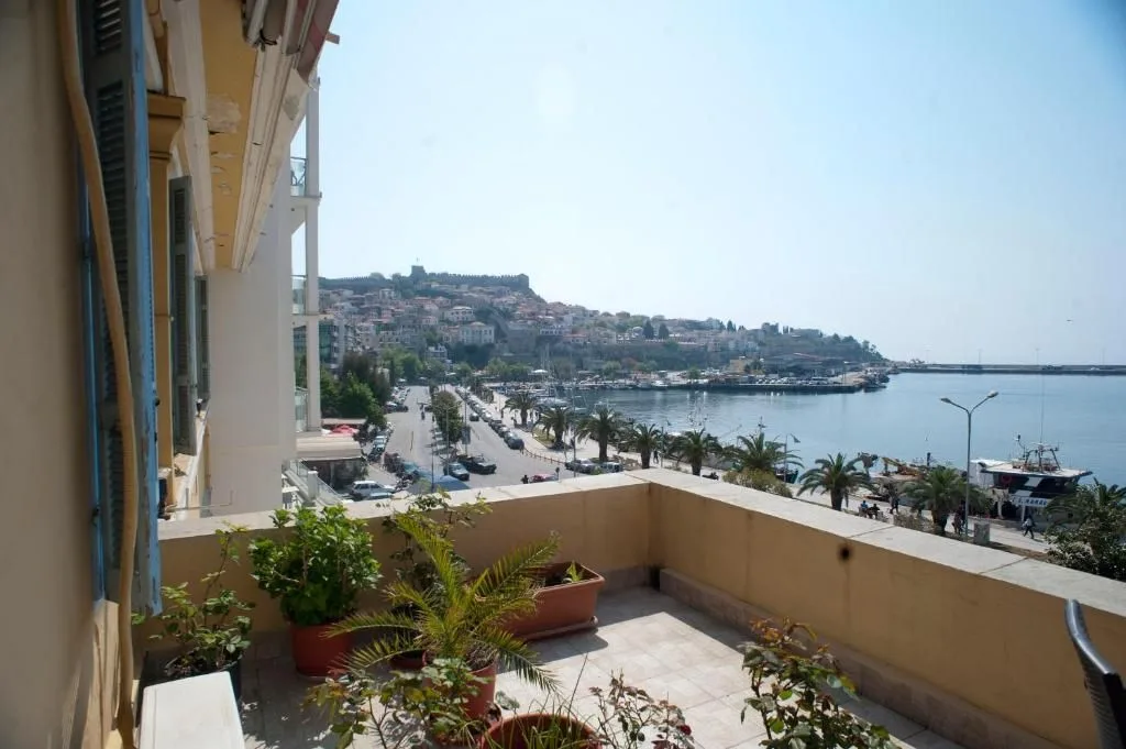 terrace with harbour view at sunset before AI photo enhancement